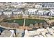 Aerial view of pond surrounded by apartments with walking bridge and fountain at 400 17Th Nw St # 2025, Atlanta, GA 30363