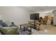 Partially furnished basement area with sofa, area rug, TV, storage and boxes at 400 17Th Nw St # 2025, Atlanta, GA 30363