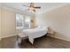 Comfortable bedroom featuring wooden floors, a ceiling fan and a large window at 400 17Th Nw St # 2025, Atlanta, GA 30363