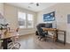 Well-lit bedroom/office space featuring a ceiling fan, large window, and wooden floors at 400 17Th Nw St # 2025, Atlanta, GA 30363