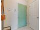 Entry way featuring a light green front door, adjacent to a white closet door and security system at 400 17Th Nw St # 2025, Atlanta, GA 30363