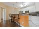 Kitchen featuring granite countertops, stainless steel appliances, and breakfast bar seating with pendant lights at 400 17Th Nw St # 2025, Atlanta, GA 30363