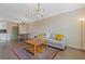 Open living and dining space with hardwood floors, a modern chandelier, and a comfortable gray couch at 400 17Th Nw St # 2025, Atlanta, GA 30363