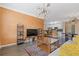 Spacious living area with wood floors, TV, stylish decor, seamlessly flowing into the kitchen and dining at 400 17Th Nw St # 2025, Atlanta, GA 30363