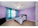 Bedroom with purple walls, double bed, and a window at 6675 Princeton Park Ct, Lithonia, GA 30058
