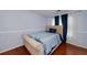 Cozy bedroom with a comfortable bed, hardwood floors, and natural light from the windows at 6675 Princeton Park Ct, Lithonia, GA 30058