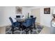 Formal dining room with modern furnishings, blue chairs and patterned rug at 6675 Princeton Park Ct, Lithonia, GA 30058