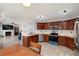 Spacious kitchen with stainless steel appliances and a view into the living room fireplace at 6675 Princeton Park Ct, Lithonia, GA 30058