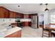 Well-lit kitchen with stainless steel appliances, wooden cabinetry, and an adjacent dining area at 6675 Princeton Park Ct, Lithonia, GA 30058