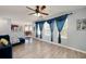 Bright living room featuring an open floor plan, and large windows with decorative curtains at 6675 Princeton Park Ct, Lithonia, GA 30058