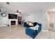 Comfortable living room featuring a fireplace, TV, and a cozy blue sectional sofa at 6675 Princeton Park Ct, Lithonia, GA 30058