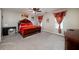 Spacious bedroom with a king-sized bed, and bright red curtains at 6675 Princeton Park Ct, Lithonia, GA 30058