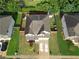 A bird's eye view of a home with a well-maintained yard, fenced backyard, and convenient driveway parking at 9348 Lantana Trl, Jonesboro, GA 30238