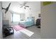 Bright bedroom featuring vinyl plank floors, blue accents, ceiling fan, and ample natural light at 9348 Lantana Trl, Jonesboro, GA 30238