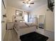 Cozy bedroom with queen-sized bed, stylish decor, fan, dark rug, and coordinating dresser at 9348 Lantana Trl, Jonesboro, GA 30238
