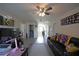 Upstairs bonus room with vinyl floors, ceiling fan, and comfortable seating area at 9348 Lantana Trl, Jonesboro, GA 30238