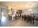 Open-concept dining area featuring modern light fixtures and bar seating adjacent to the kitchen at 9348 Lantana Trl, Jonesboro, GA 30238