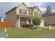 Charming two-story home with brick and vinyl siding, manicured lawn, covered front porch, and well-maintained landscaping at 9348 Lantana Trl, Jonesboro, GA 30238
