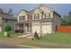 Beautiful two-story home with brick and vinyl siding, manicured lawn, two-car garage, and well-maintained landscaping at 9348 Lantana Trl, Jonesboro, GA 30238