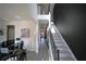 Spacious foyer with staircase, modern flooring, and adjacent home office area with desk and multiple monitors at 9348 Lantana Trl, Jonesboro, GA 30238