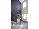 Bright, two-story foyer with staircase and black accent wall, wood-look floors, and natural light from front door windows at 9348 Lantana Trl, Jonesboro, GA 30238