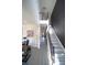Spacious foyer with staircase, modern flooring, and adjacent home office area with desk and multiple monitors at 9348 Lantana Trl, Jonesboro, GA 30238
