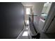Stylish staircase with dark accent wall and natural light cascading from above at 9348 Lantana Trl, Jonesboro, GA 30238