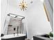 Modern bathroom features a stylish black soaking tub, rainfall showerhead and contemporary starburst light fixture at 1377 Marston St, Smyrna, GA 30080