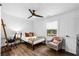 Cozy bedroom with natural light, a comfortable bed, modern fan, and hardwood floors at 1377 Marston St, Smyrna, GA 30080