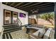 Covered outdoor patio boasts a TV and seating area perfect for relaxing and entertaining outdoors at 1377 Marston St, Smyrna, GA 30080