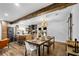 Open-concept space with modern kitchen, stainless appliances, island with seating, and elegant dining area at 1377 Marston St, Smyrna, GA 30080