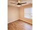 Bright bedroom featuring wood-look floors, a modern ceiling fan and window with blinds at 2302 Waldrop Pl, Decatur, GA 30034