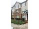 Inviting multi-story townhome features brick accents, neutral siding, and green shutters at 2302 Waldrop Pl, Decatur, GA 30034