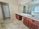 Bathroom with double sink vanity, a large mirror, tile flooring, and separate tub and shower at 2478 Brynfield Cv, Suwanee, GA 30024
