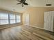 Spacious bedroom featuring vaulted ceilings, a ceiling fan, and ample natural light from three windows at 2478 Brynfield Cv, Suwanee, GA 30024