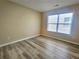 Bedroom with light walls, hardwood floors, and a bright window at 2478 Brynfield Cv, Suwanee, GA 30024