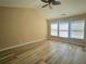 Spacious bedroom featuring vaulted ceilings, a ceiling fan, and ample natural light from three windows at 2478 Brynfield Cv, Suwanee, GA 30024
