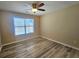 Bedroom featuring wood-look flooring, neutral walls, and natural light at 2478 Brynfield Cv, Suwanee, GA 30024