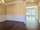 Open dining area with hardwood floors and a view into the living room at 2478 Brynfield Cv, Suwanee, GA 30024