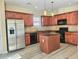 Well-equipped kitchen with stainless appliances, wooden island, and ample cabinet space at 2478 Brynfield Cv, Suwanee, GA 30024