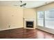 Cozy living room featuring a fireplace, hardwood floors, and natural light at 2478 Brynfield Cv, Suwanee, GA 30024