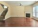 Bright living room with a fireplace, hardwood floors, and large windows at 2478 Brynfield Cv, Suwanee, GA 30024