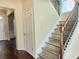 View of the staircase with wood steps and railing, leading to the second floor of the home at 2478 Brynfield Cv, Suwanee, GA 30024