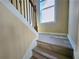 Close-up view of staircase with wood steps, trim, and window, ascending to the next level at 2478 Brynfield Cv, Suwanee, GA 30024
