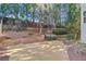 Landscaped backyard featuring a newly planted grass area with wooden retaining walls and a partially wooded area at 3311 Fieldwood Se Dr, Smyrna, GA 30080