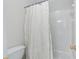 Bathroom showcasing a bathtub with a white tile surround and shower featuring a shower curtain at 3311 Fieldwood Se Dr, Smyrna, GA 30080