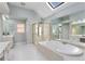 Bright bathroom with a skylight, large tub, double sinks, and glass shower at 3311 Fieldwood Se Dr, Smyrna, GA 30080