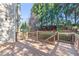 Large wooden deck with railings and privacy trees in a backyard at 3311 Fieldwood Se Dr, Smyrna, GA 30080