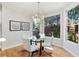 Bright breakfast nook with hardwood floors, chandelier, and large windows overlooking the landscaped backyard at 3311 Fieldwood Se Dr, Smyrna, GA 30080