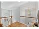 Hallway with hardwood floors, wooden railing and natural light from a window near the stairwell at 3311 Fieldwood Se Dr, Smyrna, GA 30080